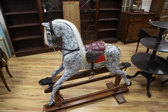 An Edwardian trestle base painted rocking horse, L.4ft 8in.